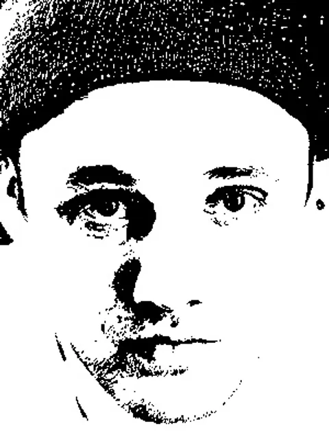 A close up of Dom Storrs' face in black and white.